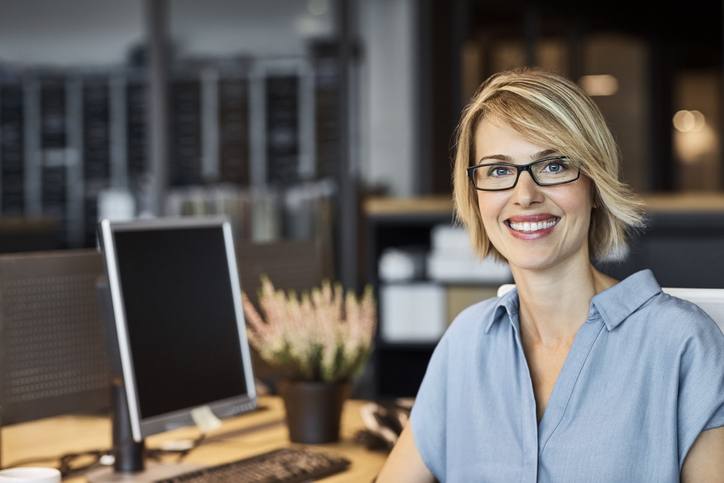 Confident businesswoman smiling in office